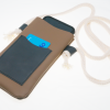 Brown leather phone pouch with cotton cord showing with mobile phone